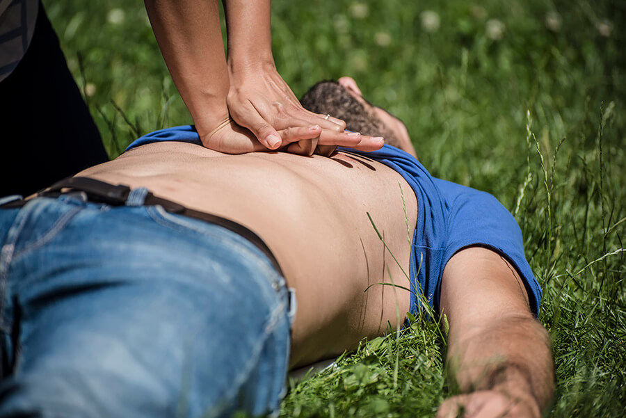 CPR on person on a lawn